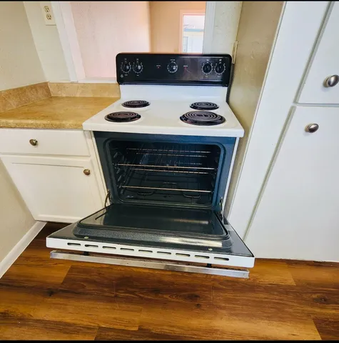 a stove top oven sitting inside of a kitchen