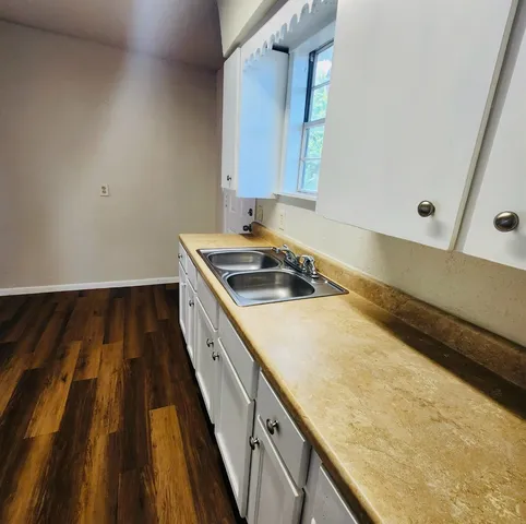 a kitchen with sink and cabinets