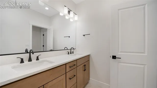 a bathroom with a double vanity sink and mirror
