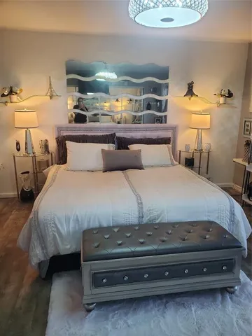 a bedroom with a bed and a mirror