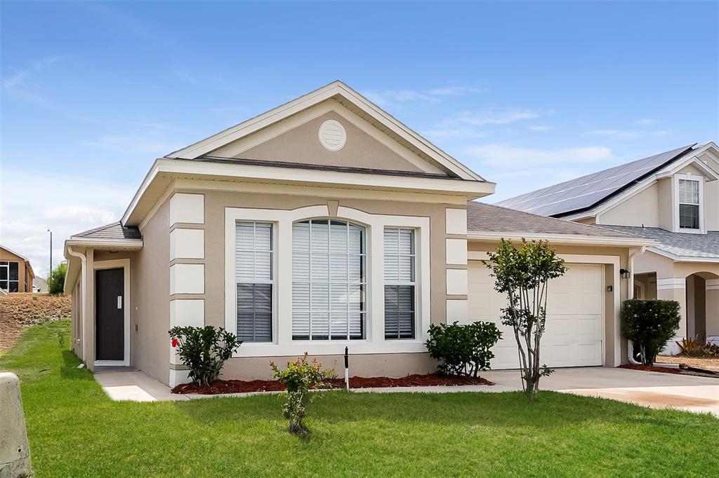 623 Nicholson Drive Davenport, FL 33837 - Photo 1 of 1 a front view of a house with a yard and garage