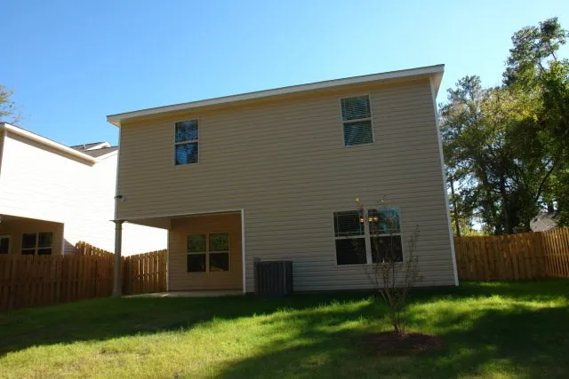 a view of backyard of house with green space