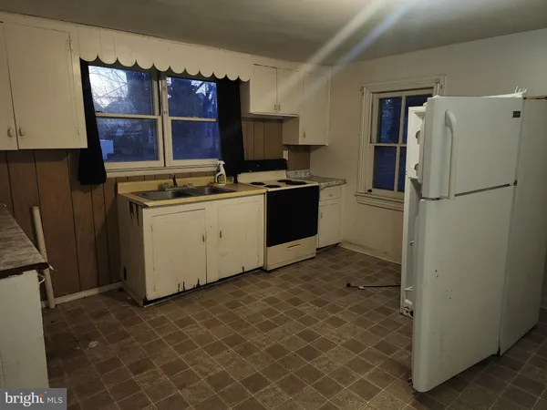 a kitchen with stainless steel appliances granite countertop a refrigerator a stove and a sink