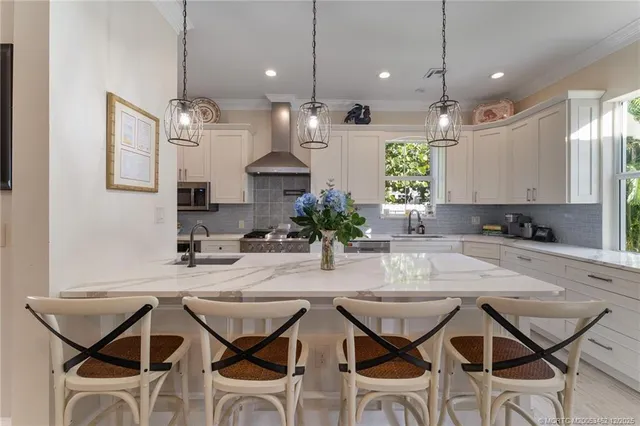 a large kitchen with a sink and stainless steel appliances
