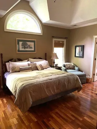 a bedroom with a bed and a window