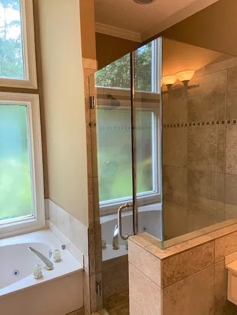 a bathroom with a bathtub and a shower
