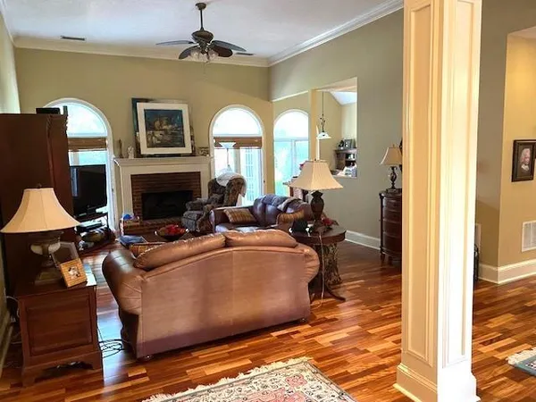 a living room with fireplace furniture and a window