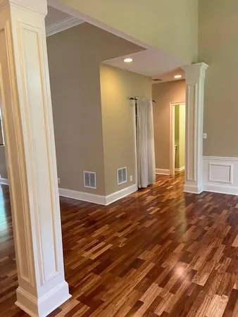 a view of a room with wooden floor