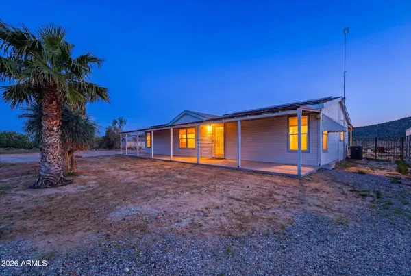 a view of a house with backyard and trees