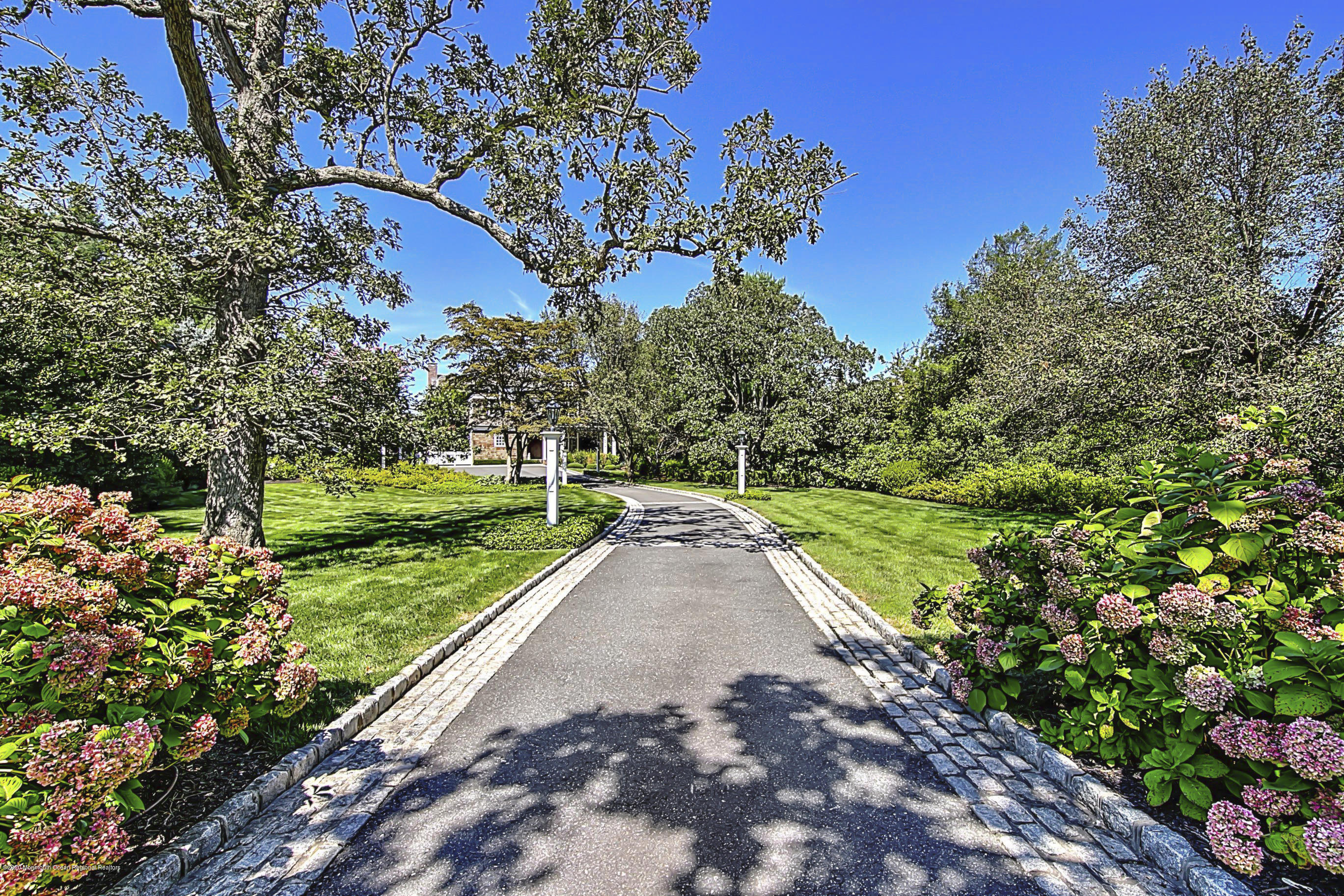 62 River Road Rumson, NJ 07760 - Photo 2 of 54 a view of a street with a tree in the background
