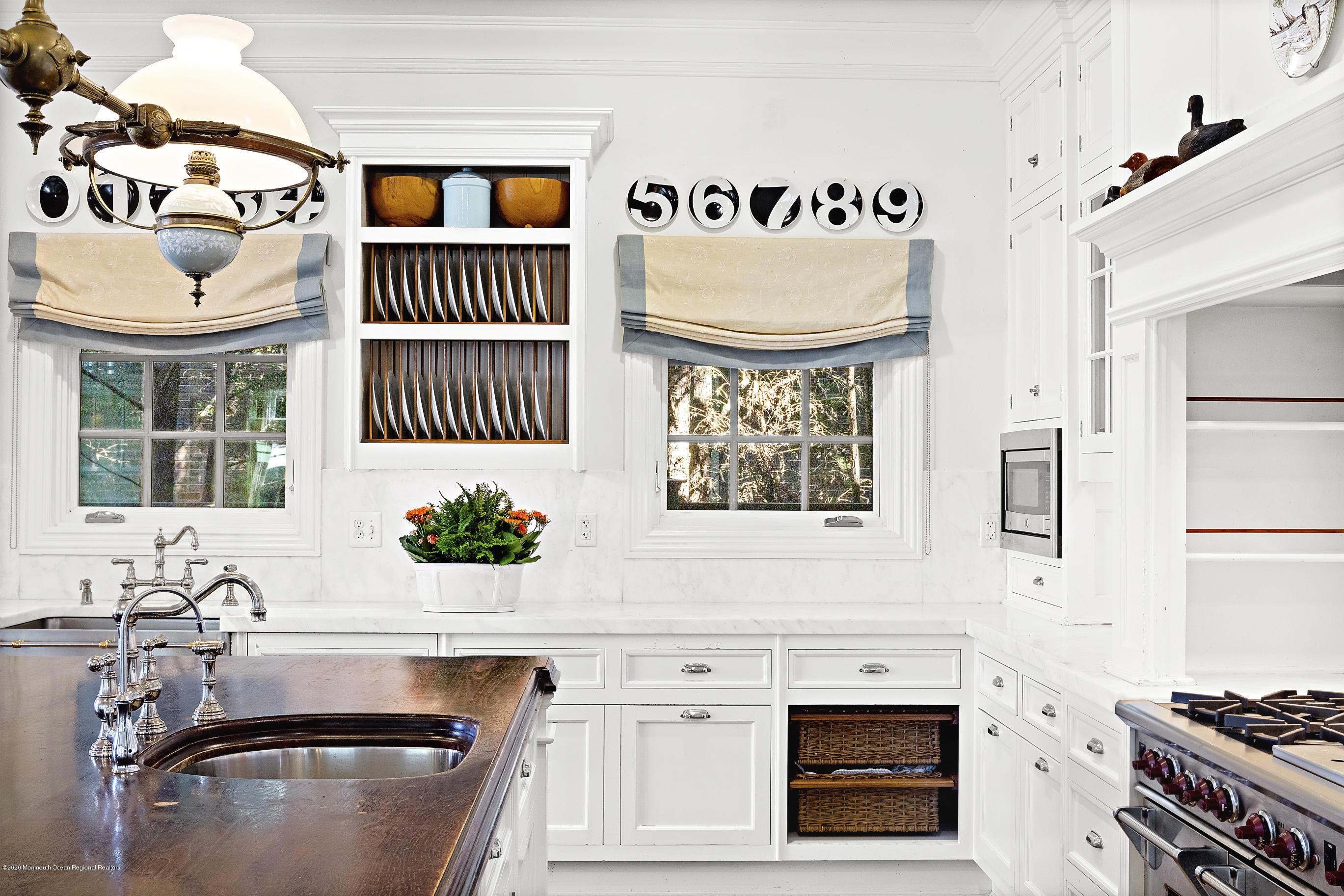 62 River Road Rumson, NJ 07760 - Photo 26 of 54 a kitchen with a stove a sink and a refrigerator