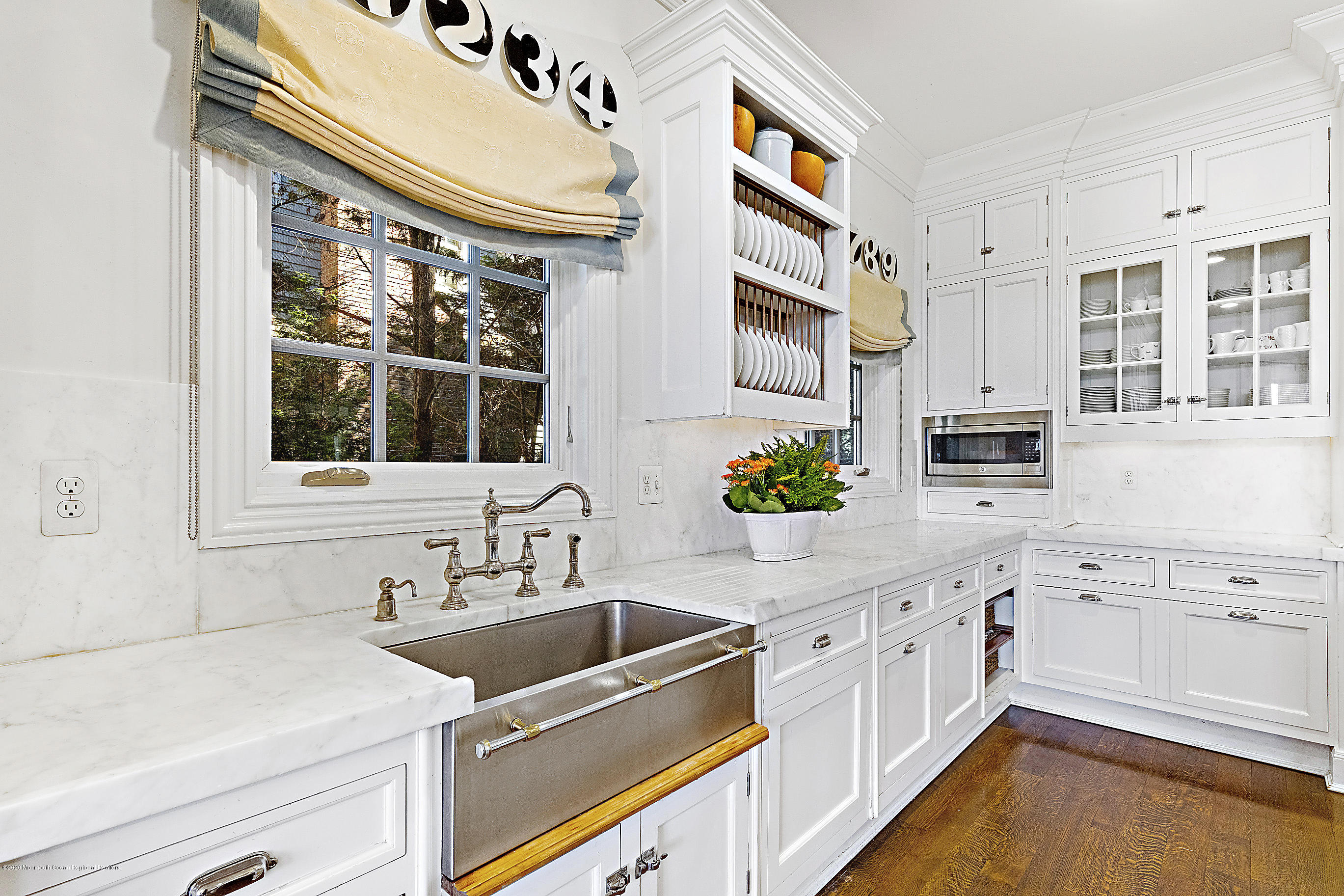 62 River Road Rumson, NJ 07760 - Photo 27 of 54 a kitchen with stainless steel appliances granite countertop a sink and cabinets