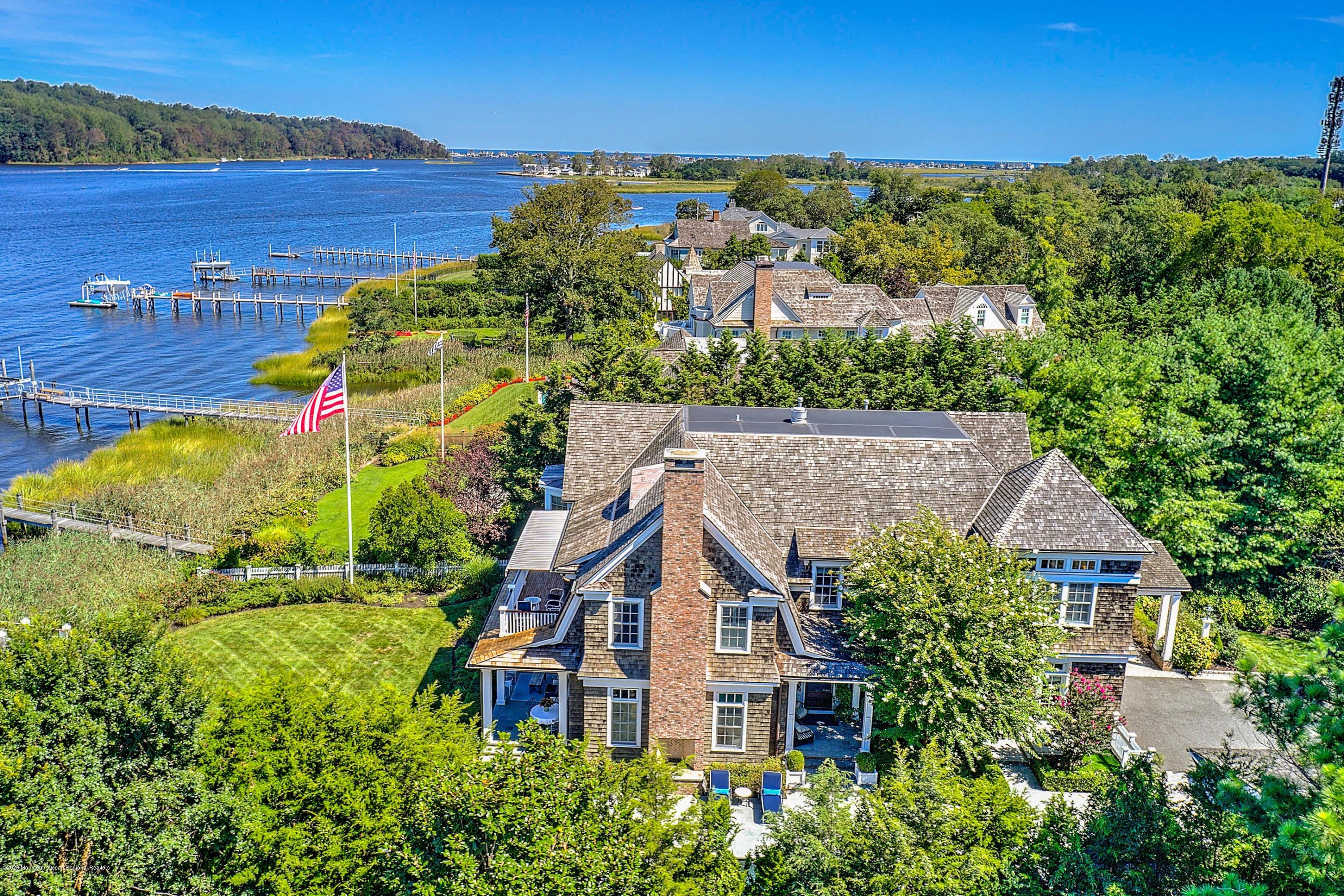 62 River Road Rumson, NJ 07760 - Photo 4 of 54 an aerial view of a house with a garden and lake view