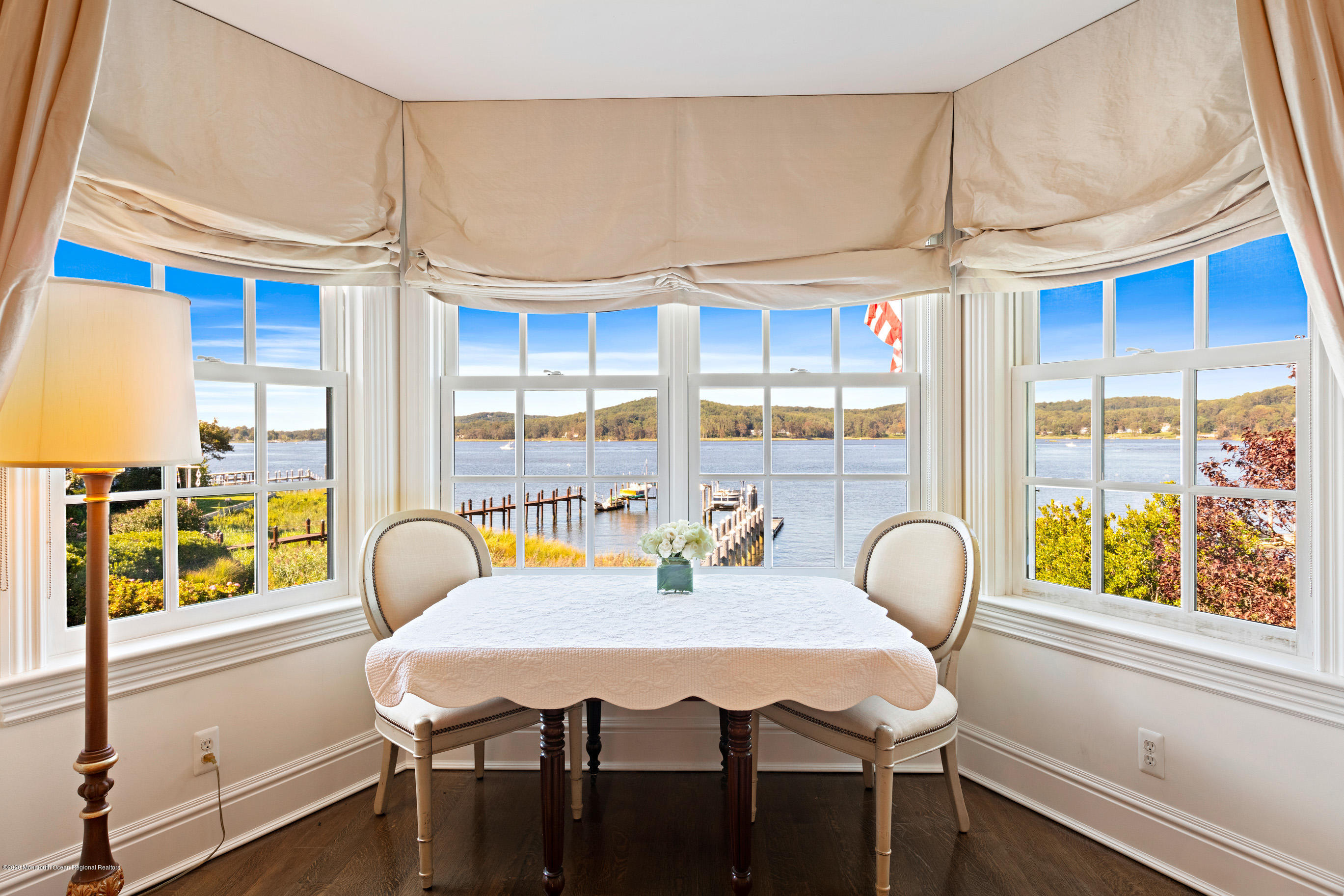 62 River Road Rumson, NJ 07760 - Photo 34 of 54 a view of a dining room with furniture a chandelier and wooden floor