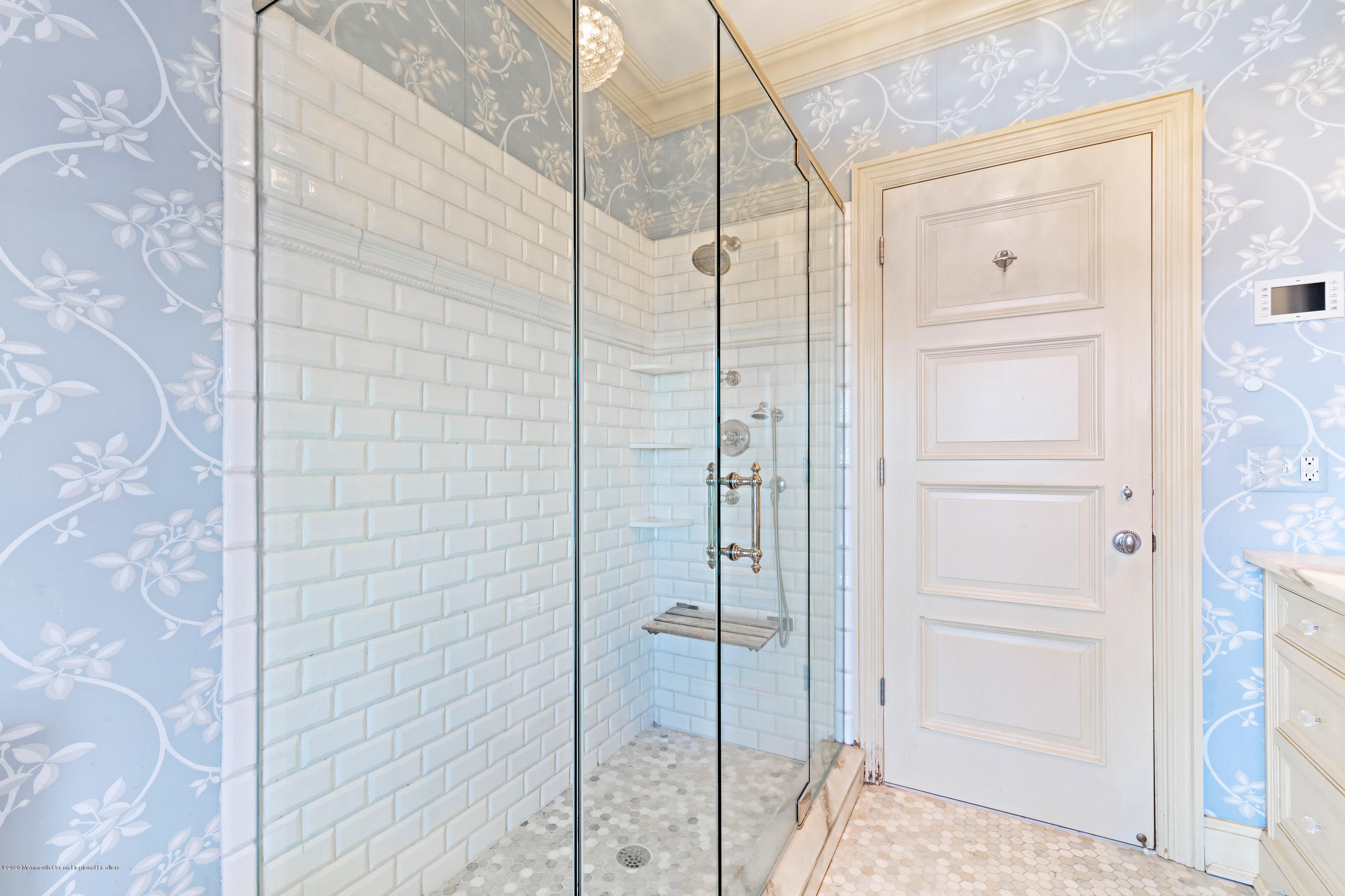 62 River Road Rumson, NJ 07760 - Photo 39 of 54 a bathroom with a glass shower door