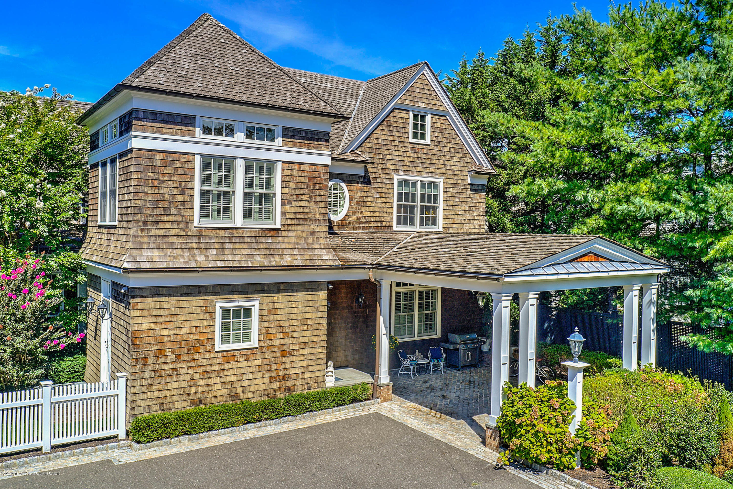 62 River Road Rumson, NJ 07760 - Photo 5 of 54 a front view of a house with a yard and potted plants