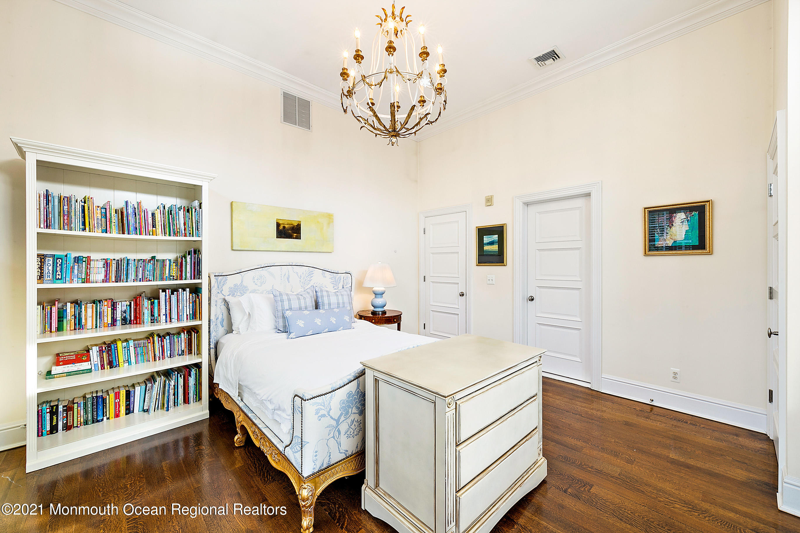 62 River Road Rumson, NJ 07760 - Photo 41 of 54 a bedroom with a bed and a book shelf