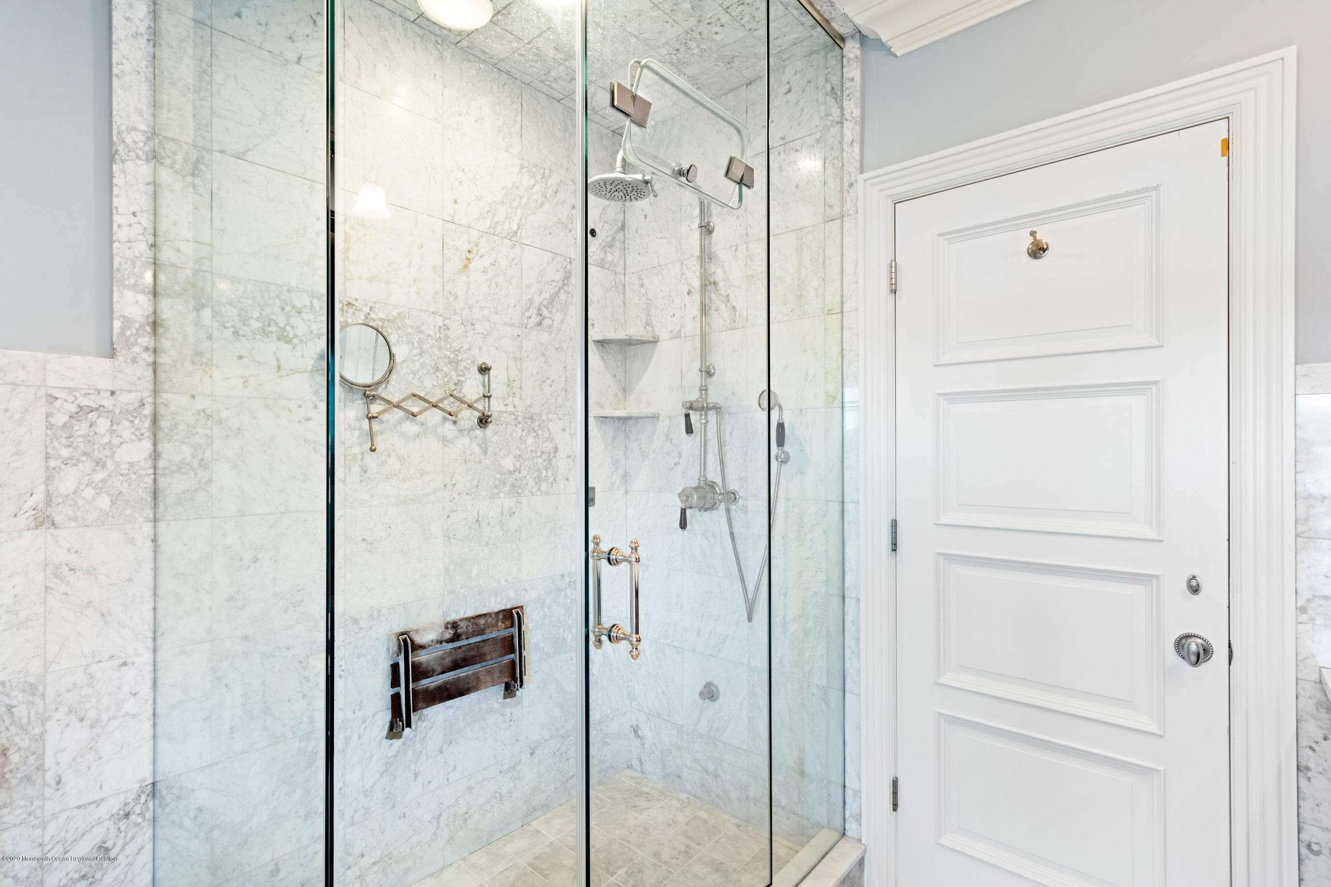 62 River Road Rumson, NJ 07760 - Photo 43 of 54 a bathroom with a glass shower door