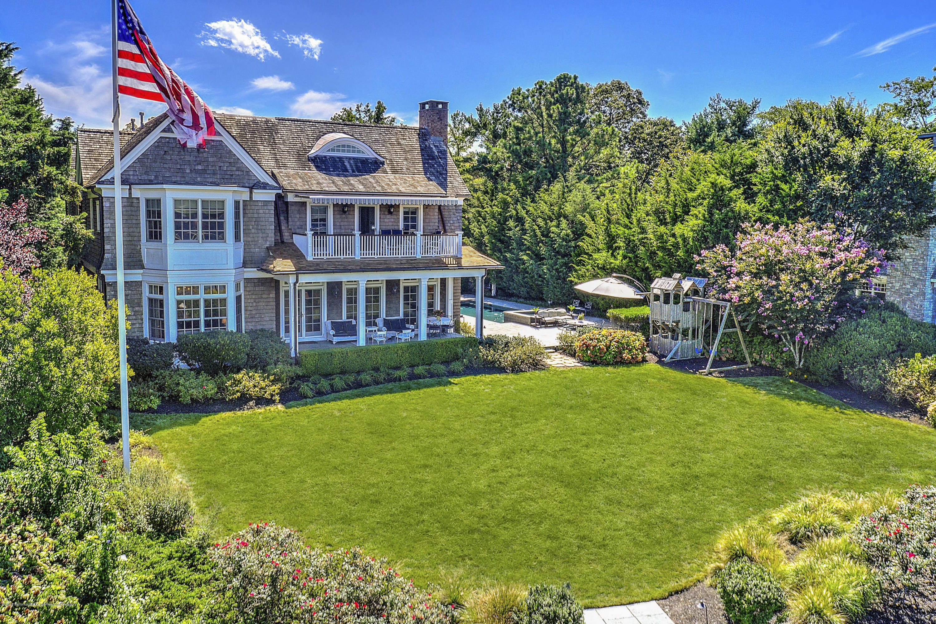 62 River Road Rumson, NJ 07760 - Photo 9 of 54 a front view of a house with a yard