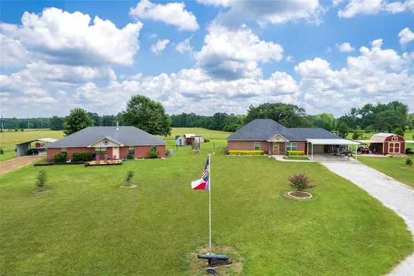 a aerial view of a house with swimming pool and big yard
