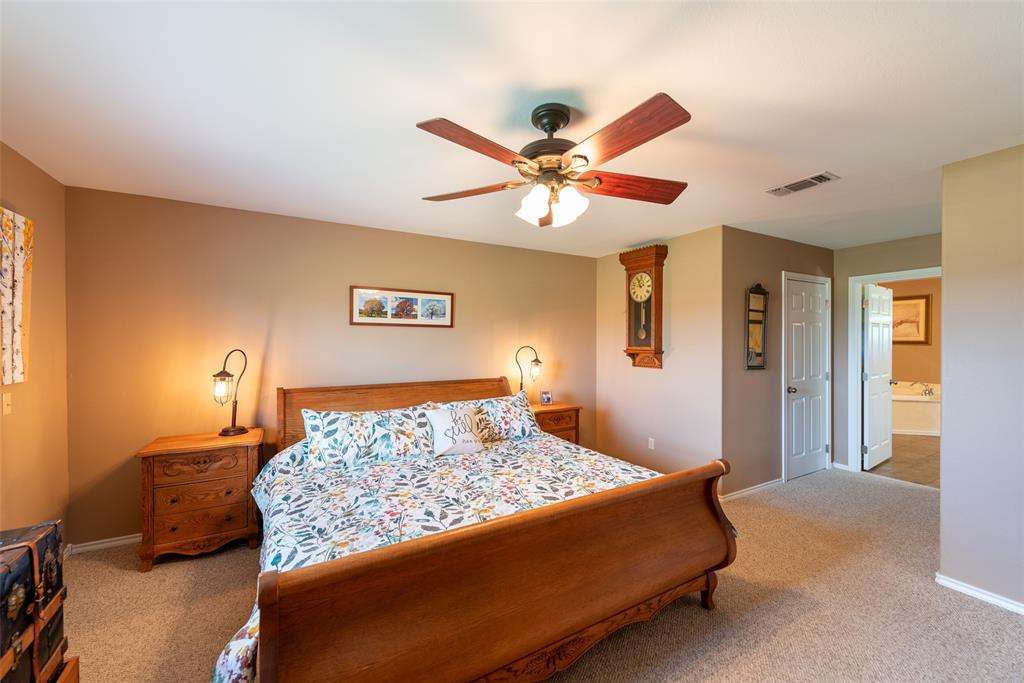 6888 Fm 2888 Naples, TX 75568 - Photo 13 of 40 a bedroom with a bed and a chandelier