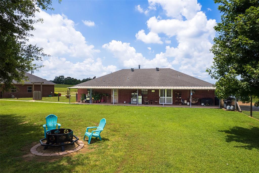 6888 Fm 2888 Naples, TX 75568 - Photo 15 of 40 a view of a house with backyard sitting area and garden