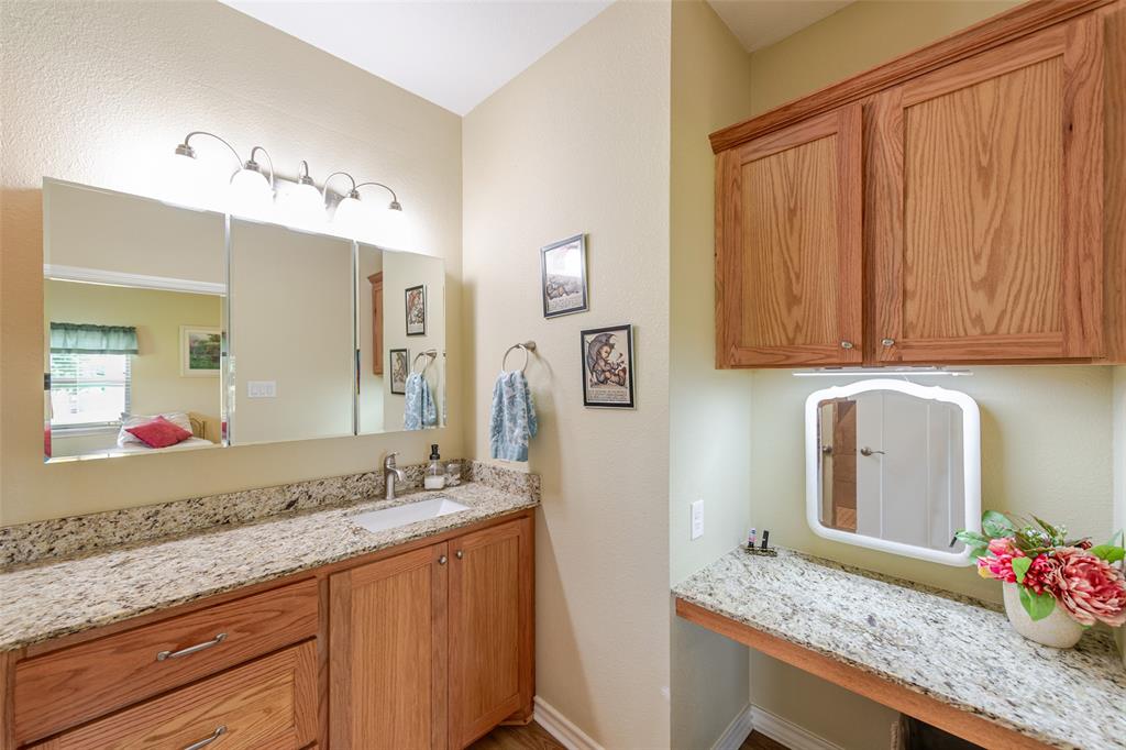 6888 Fm 2888 Naples, TX 75568 - Photo 29 of 40 a bathroom with granite countertop sink and a mirror