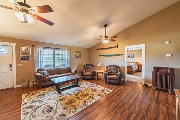 a living room with furniture and wooden floor