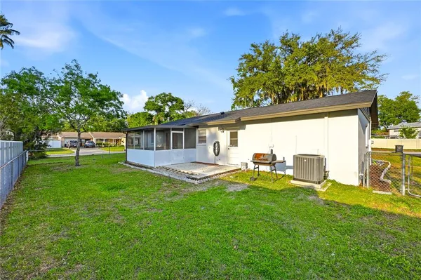 a view of a house with backyard porch and sitting area