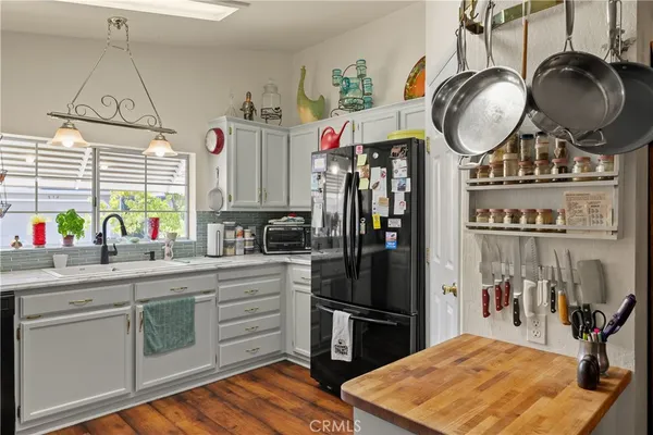 a kitchen with stainless steel appliances granite countertop a sink a refrigerator and a stove