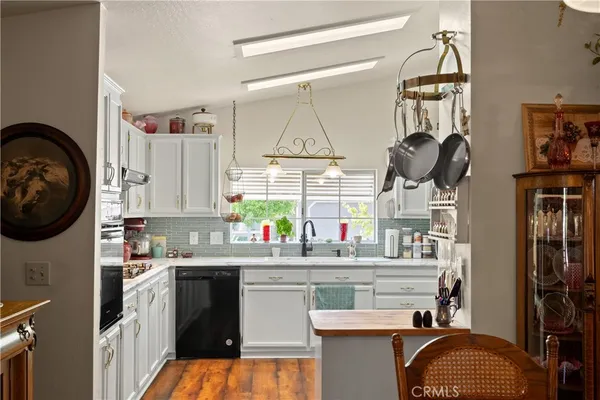a kitchen with a sink cabinets and appliances