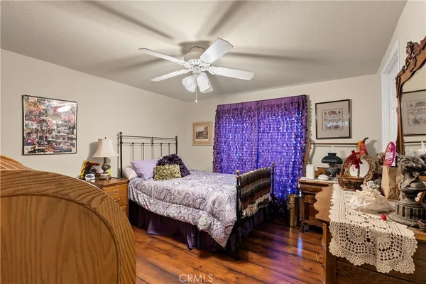 a bedroom with bed and wooden floor
