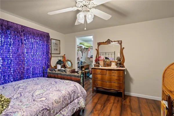 a bedroom with bed and wooden floor