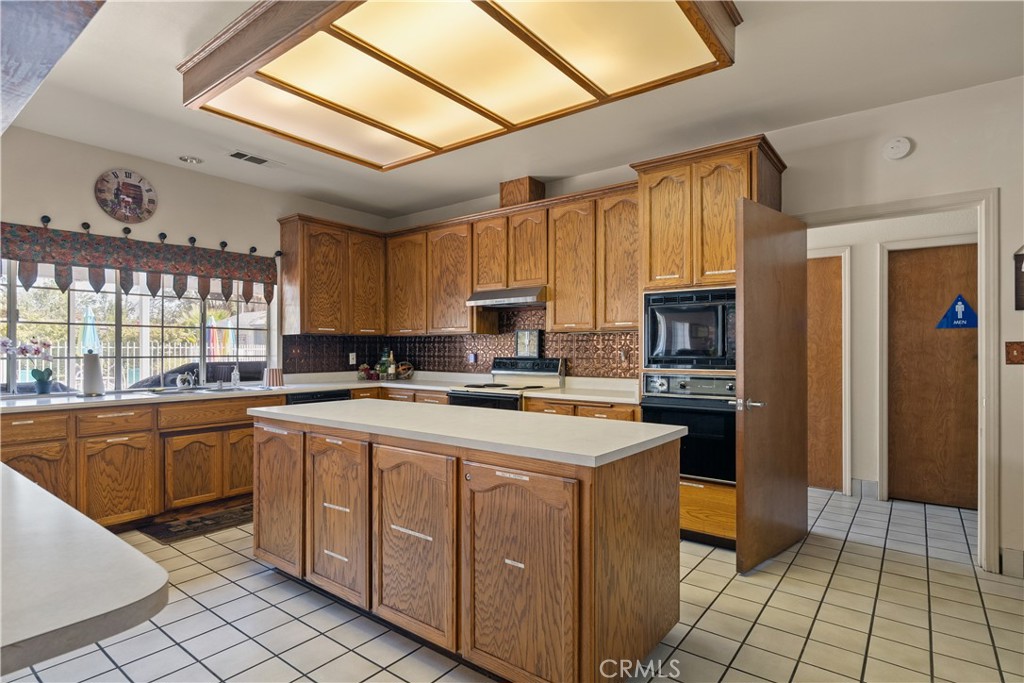 2050 Springfield Drive, Unit 215 Chico, CA 95928 - Photo 44 of 53 a kitchen with a sink a stove top oven and cabinetry