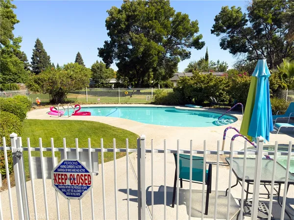 a view of swimming pool with a table and chairs