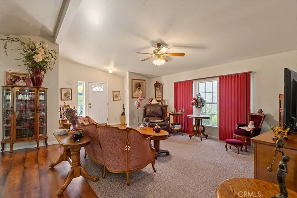 a living room with furniture a flat screen tv and a window