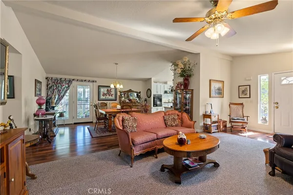 a living room with furniture and a chandelier
