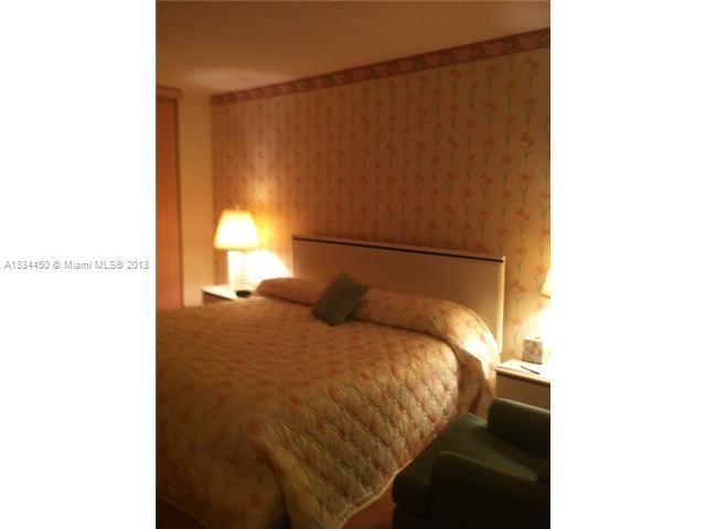 9273 Collins Avenue, Unit 503 Surfside, FL 33154 - Photo 11 of 14 a bedroom with a bed and a window
