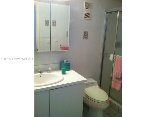 9273 Collins Avenue, Unit 503 Surfside, FL 33154 - Photo 13 of 14 a bathroom with a sink and a toilet