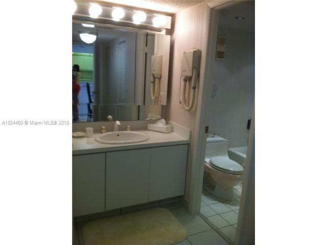 9273 Collins Avenue, Unit 503 Surfside, FL 33154 - Photo 14 of 14 a bathroom with a sink toilet and shower