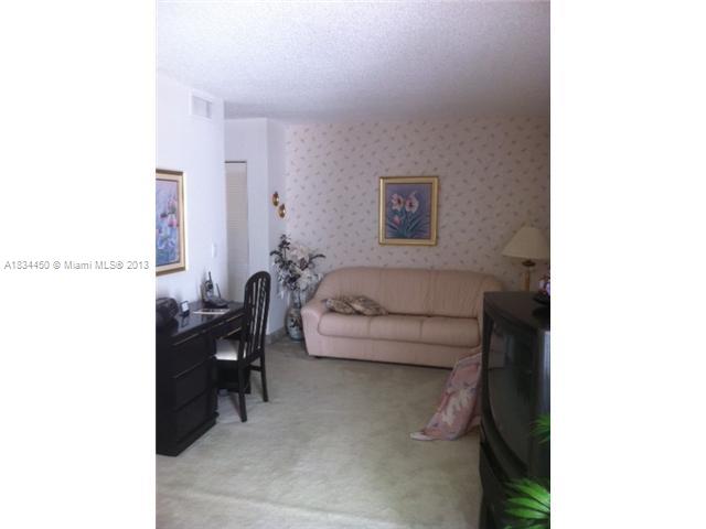 9273 Collins Avenue, Unit 503 Surfside, FL 33154 - Photo 10 of 14 a living room with furniture and a table