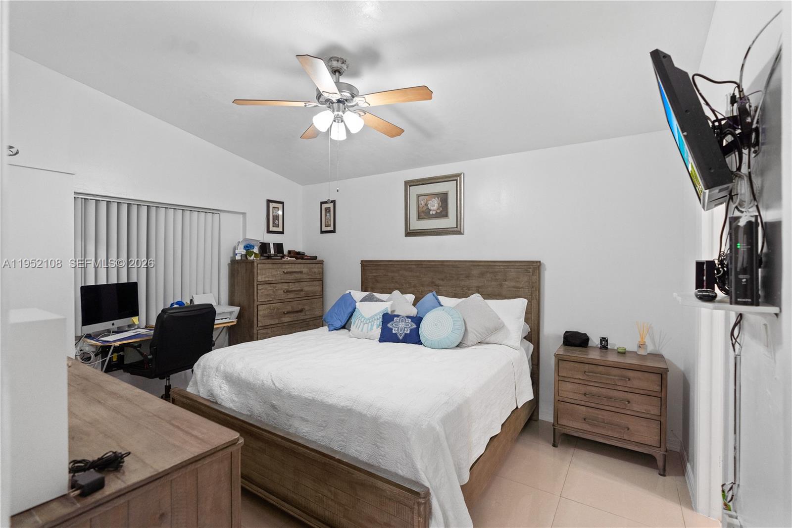 6919 West 29th Way Hialeah, FL 33018 - Photo 11 of 23 a bedroom with a bed and a flat screen tv