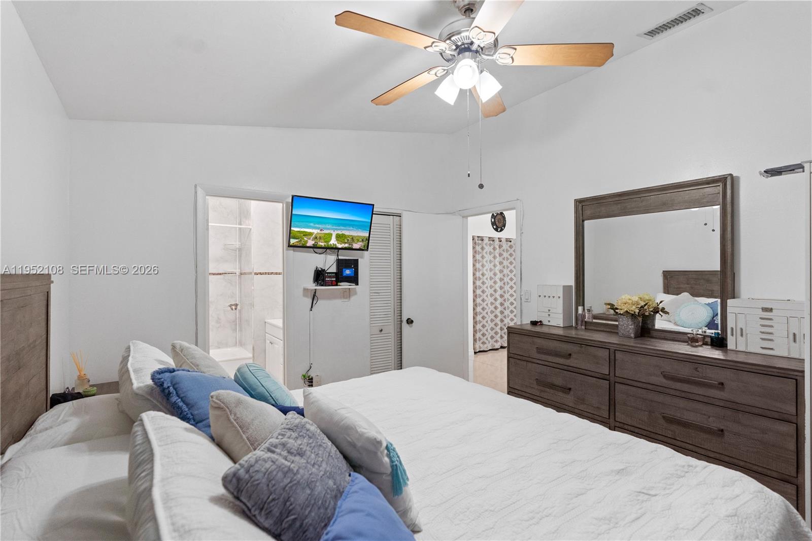 6919 West 29th Way Hialeah, FL 33018 - Photo 12 of 23 a bedroom with a bed and a chandelier