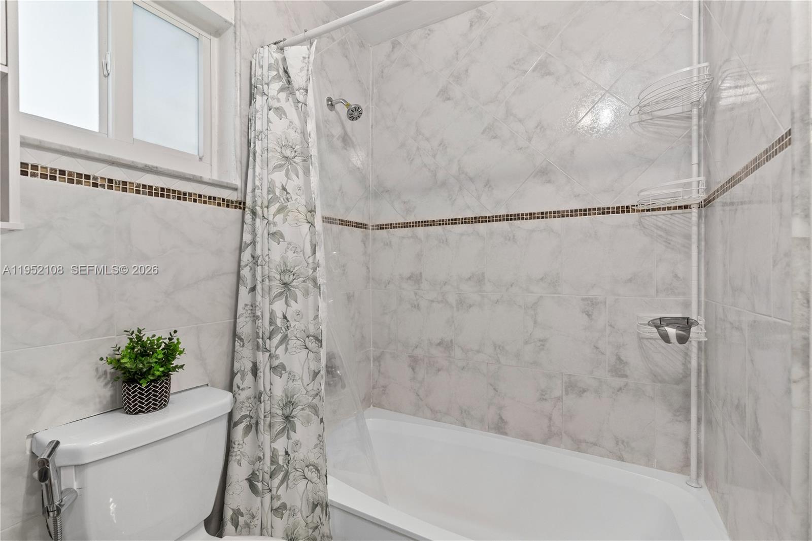 6919 West 29th Way Hialeah, FL 33018 - Photo 14 of 23 a bathroom with a shower and a toilet