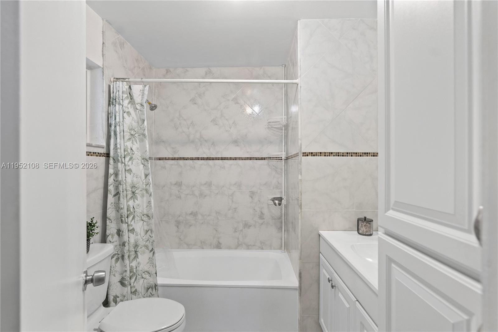 6919 West 29th Way Hialeah, FL 33018 - Photo 15 of 23 a bathroom with a shower curtain and a sink