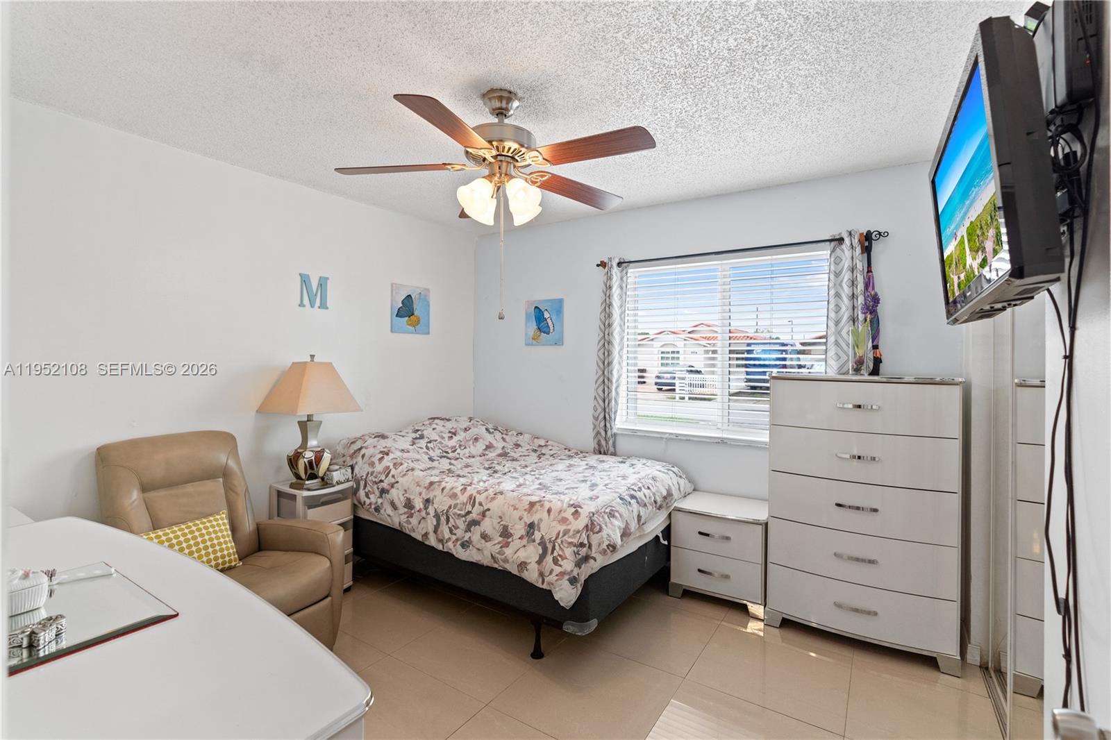 6919 West 29th Way Hialeah, FL 33018 - Photo 17 of 23 a bedroom with a bed and a chandelier