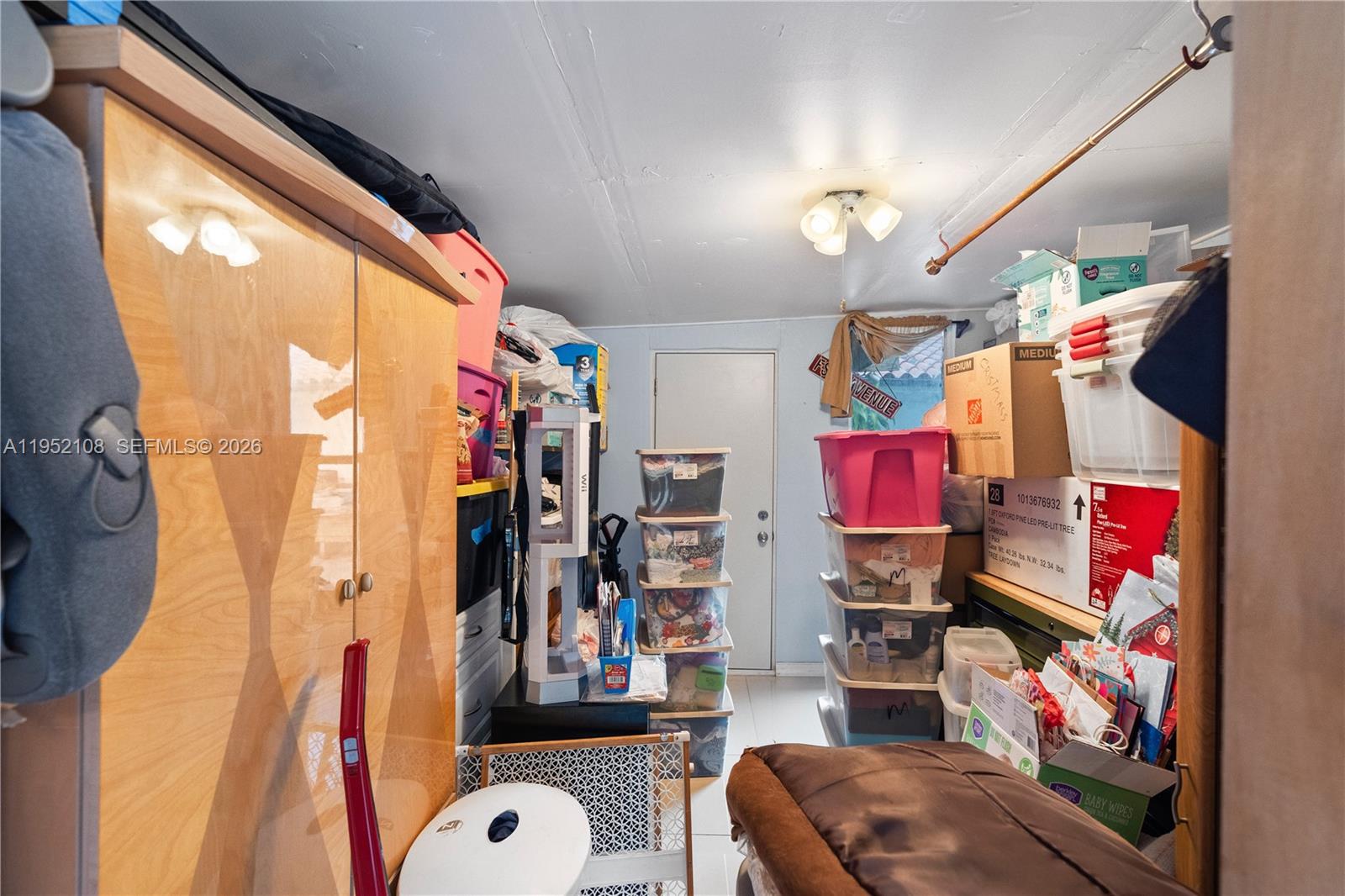 6919 West 29th Way Hialeah, FL 33018 - Photo 20 of 23 a view of walk in closet with clothes and shoes