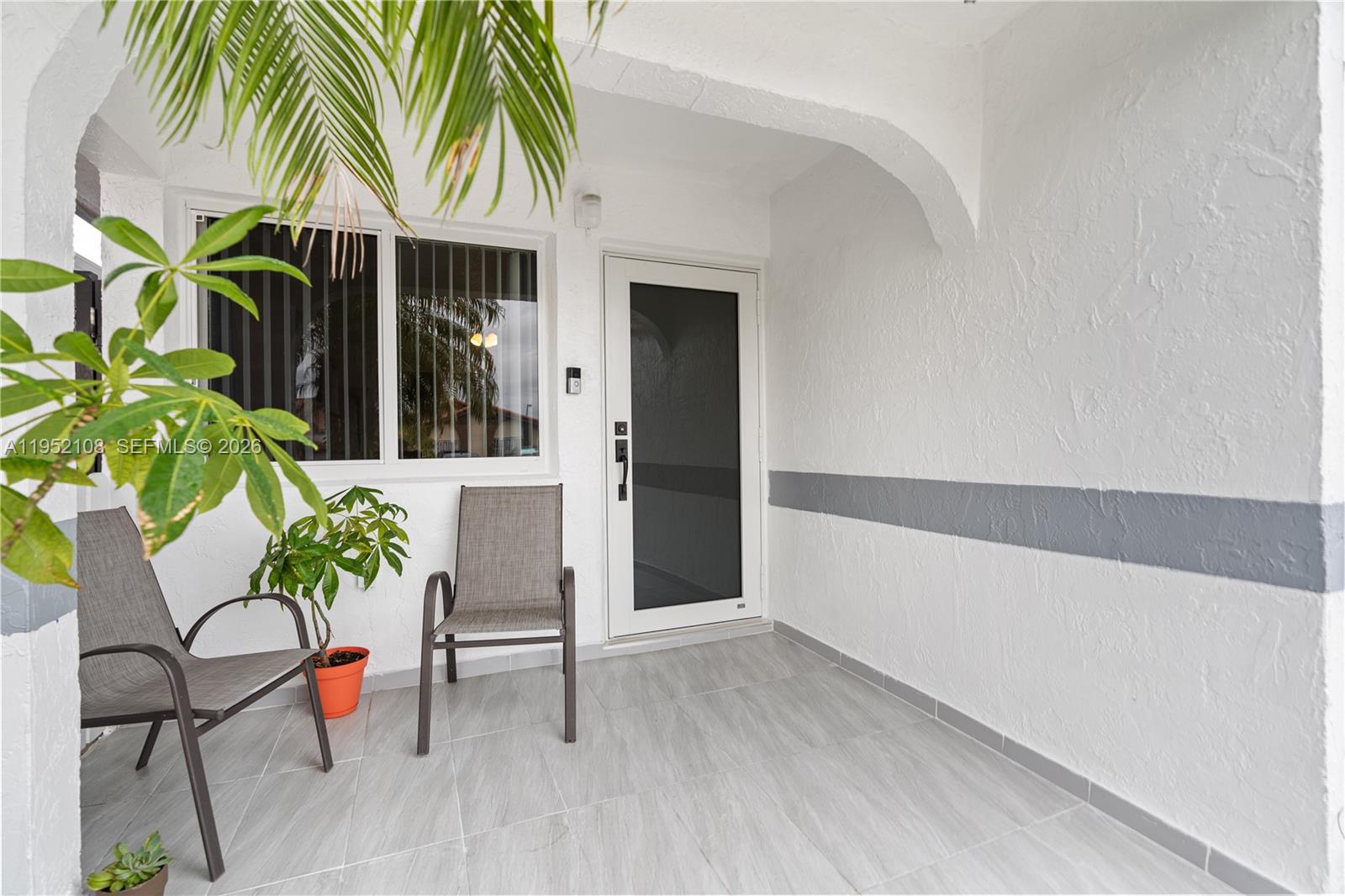 6919 West 29th Way Hialeah, FL 33018 - Photo 2 of 23 a living room with furniture and a potted plant