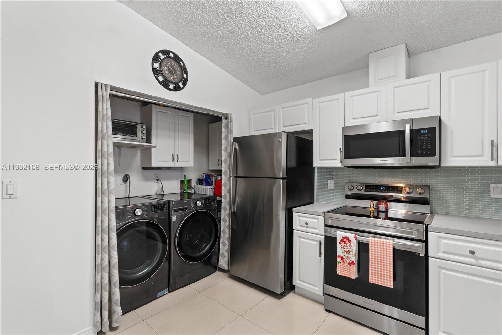 6919 West 29th Way Hialeah, FL 33018 - Photo 6 of 23 a kitchen with stainless steel appliances granite countertop a refrigerator and a stove top oven
