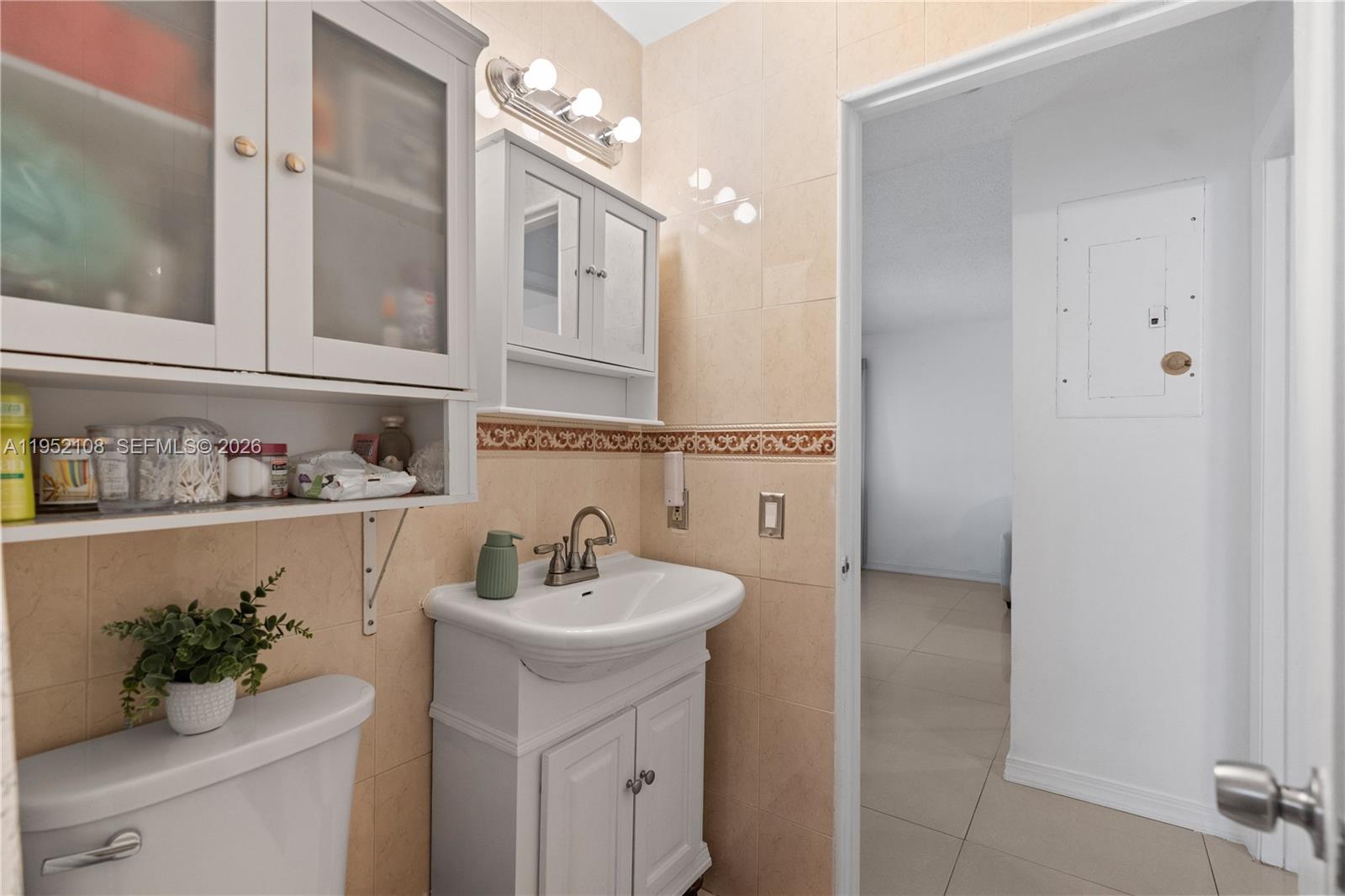6919 West 29th Way Hialeah, FL 33018 - Photo 9 of 23 a bathroom with a sink double vanity and a mirror
